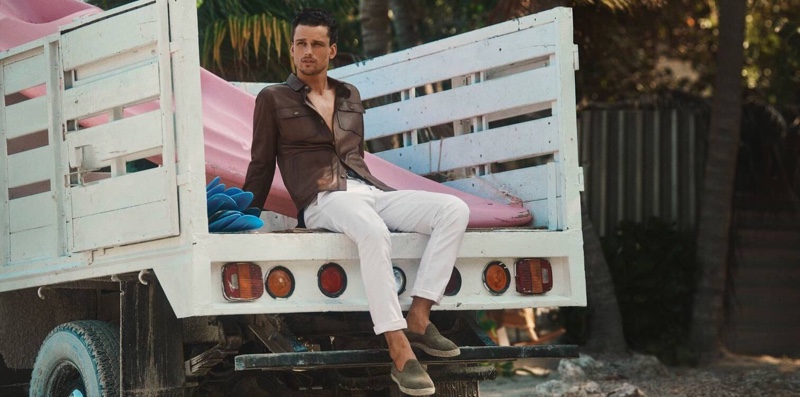 Sporting a leather shirt with white pants, Simon Nessman fronts Massimo Dutti's spring-summer 2020 campaign.