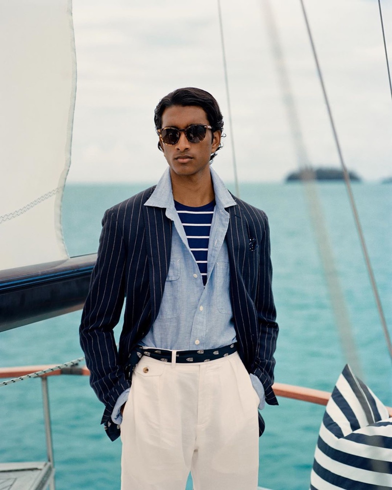 Jeenu Mahadevan embraces smart style in a pinstripe jacket, linen shirt, striped tee, and beige trousers from POLO Ralph Lauren.