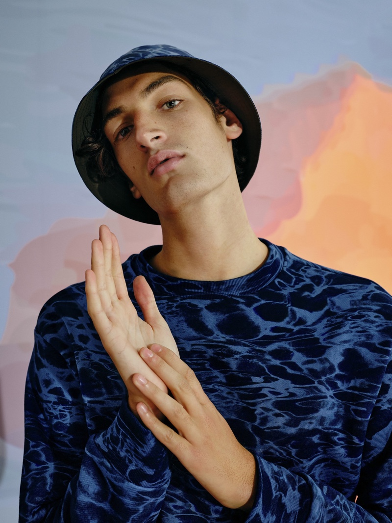 Channeling nineties style, Aaron Shandel sports a matching t-shirt and bucket hat from Reserved's Re Design collection.
