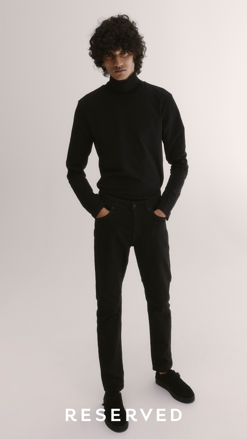 Wearing all black, Mustafa Dawood models a turtleneck with jeans from Reserved.