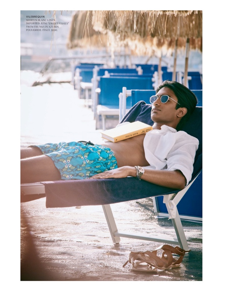 Relaxing poolside, Rishi Robin sports a linen shirt and swim trunks from Vilebrequin for Bergdorf Goodman.