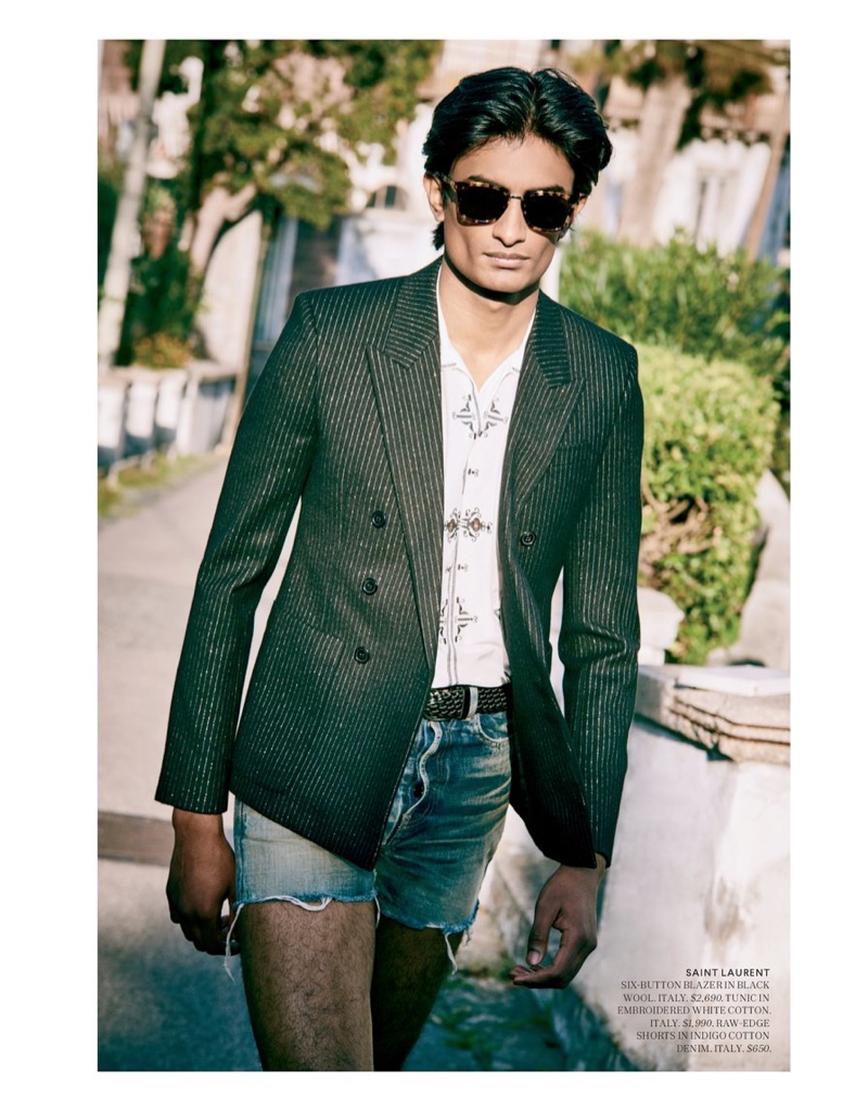 Donning bold style, Rishi Robin sports a blazer with raw-edge denim shorts and a shirt from Saint Laurent for Bergdorf Goodman.