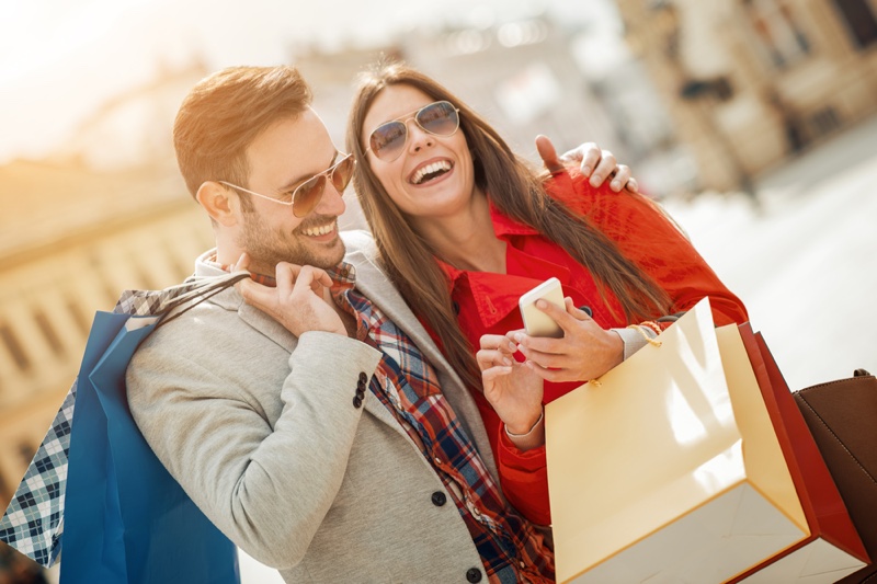 Smiling Couple Shopping Bags Sunglasses