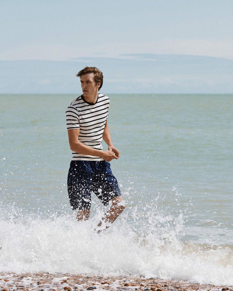 Taking to the beach, Tim Dibble appears in Sunspel's spring-summer 2020 campaign.