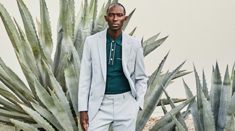 A smart vision, Armando Cabral wears a Todd Snyder Italian cotton silk tipped ribbed polo sweater in green with a Todd Snyder Black Label Sutton fine corded suit.