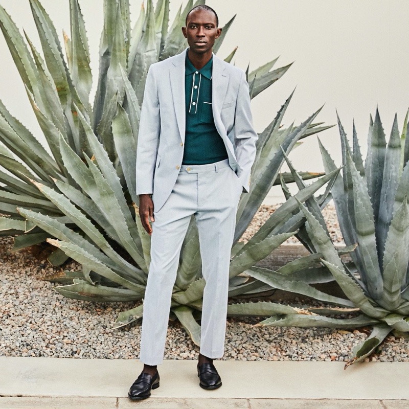 A smart vision, Armando Cabral wears a Todd Snyder Italian cotton silk tipped ribbed polo sweater in green with a Todd Snyder Black Label Sutton fine corded suit.