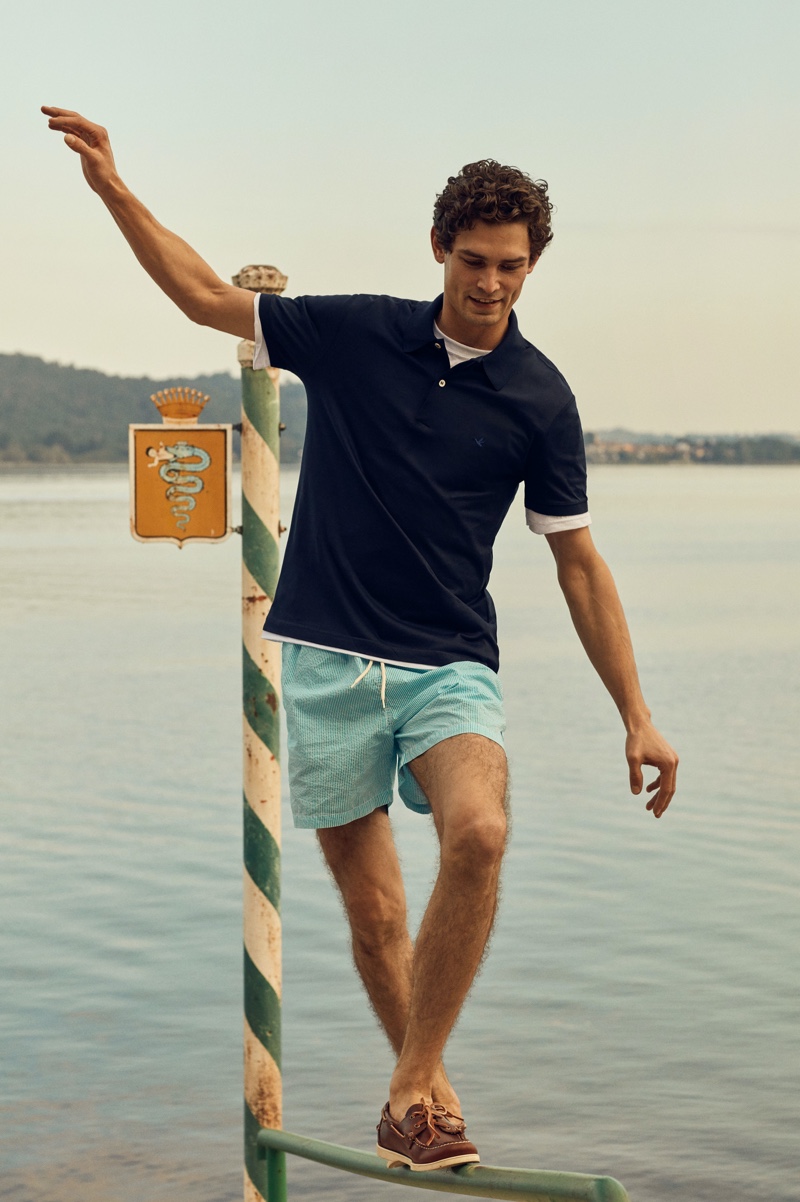 Dressed for warm weather, Arthur Gosse models a polo shirt with swim shorts from Brooksfield.