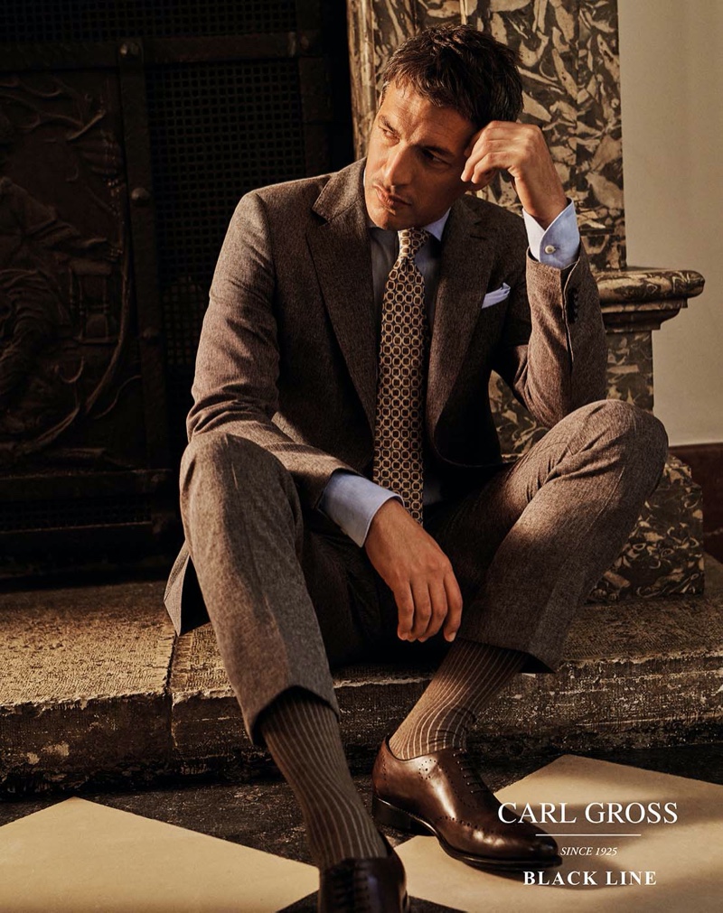 Making a case for brown, Ilay Kurelovic dons a sleek suit from Carl Gross Black Line's spring-summer 2020 collection.