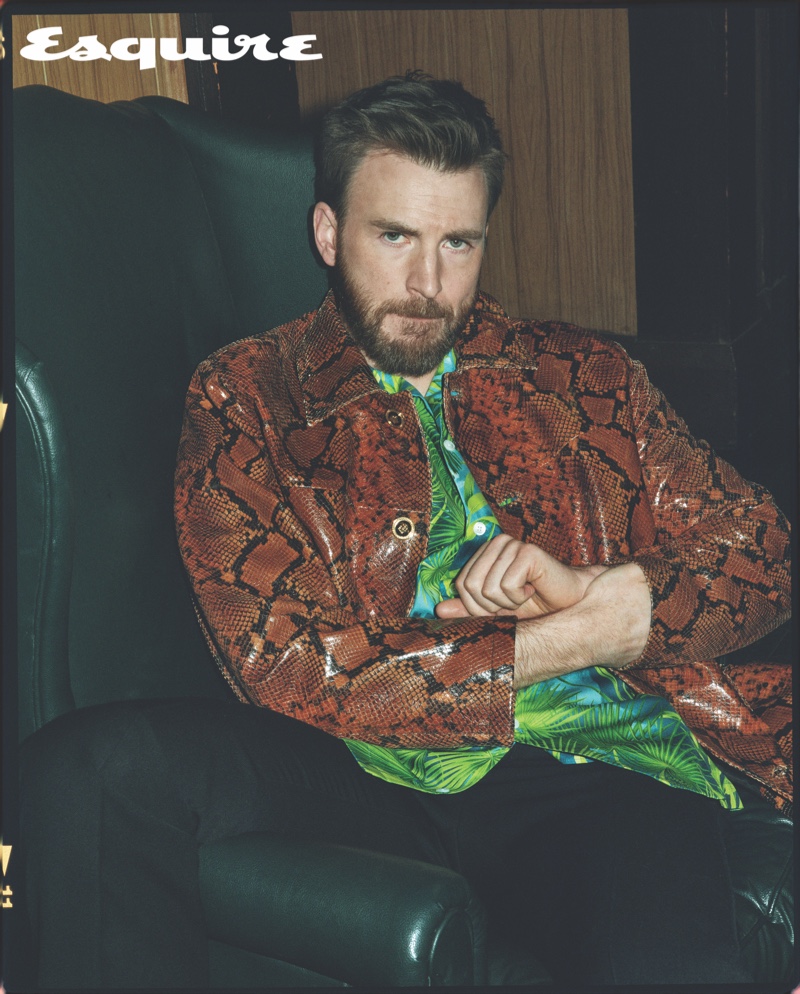 Starring in a new Esquire photo shoot, Chris Evans wears a shirt, snake print jacket, and pants by Versace. A RRL belt completes his designer look.