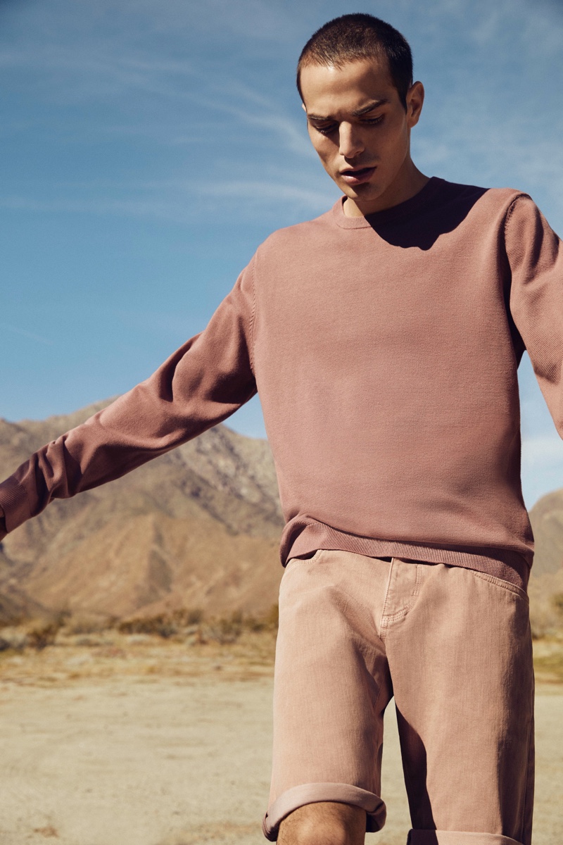 Embracing monochromatic style, David Friend dons a sweatshirt and shorts from Esprit's EarthColors capsule collection.