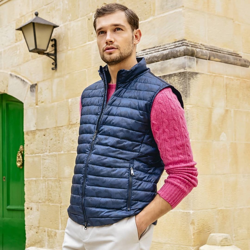 Connecting with GEOX for its spring-summer 2020 campaign, Stefan Pollmann wears a quilted vest with a cable-knit sweater.