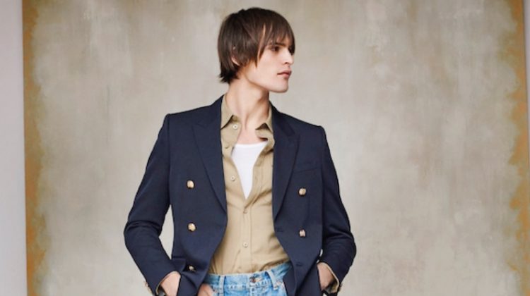 Holt Renfrew makes a case for relaxed tailoring as Parker van Noord sports a look from Celine. The top model wears Celine's double-breasted blazer, military shirt, tank, flared jeans, and sneakers.