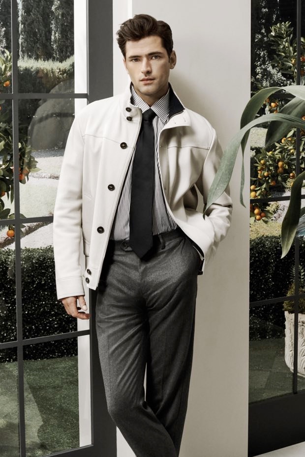 Sean O'Pry dons a Brioni leather bomber jacket with a striped shirt, wool trousers, and tie.