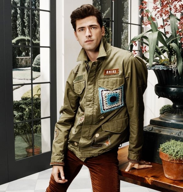 American model Sean O'Pry sports an AMIRI military short parka with the brand's velour skinny stack pants.