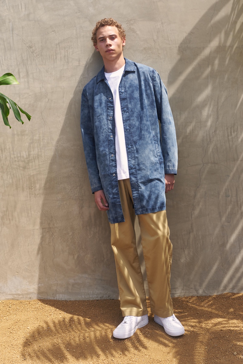 Front and center, Lye-Amone Cassac models a drop shoulder mackintosh with relaxed chinos from Levi's Made & Crafted.