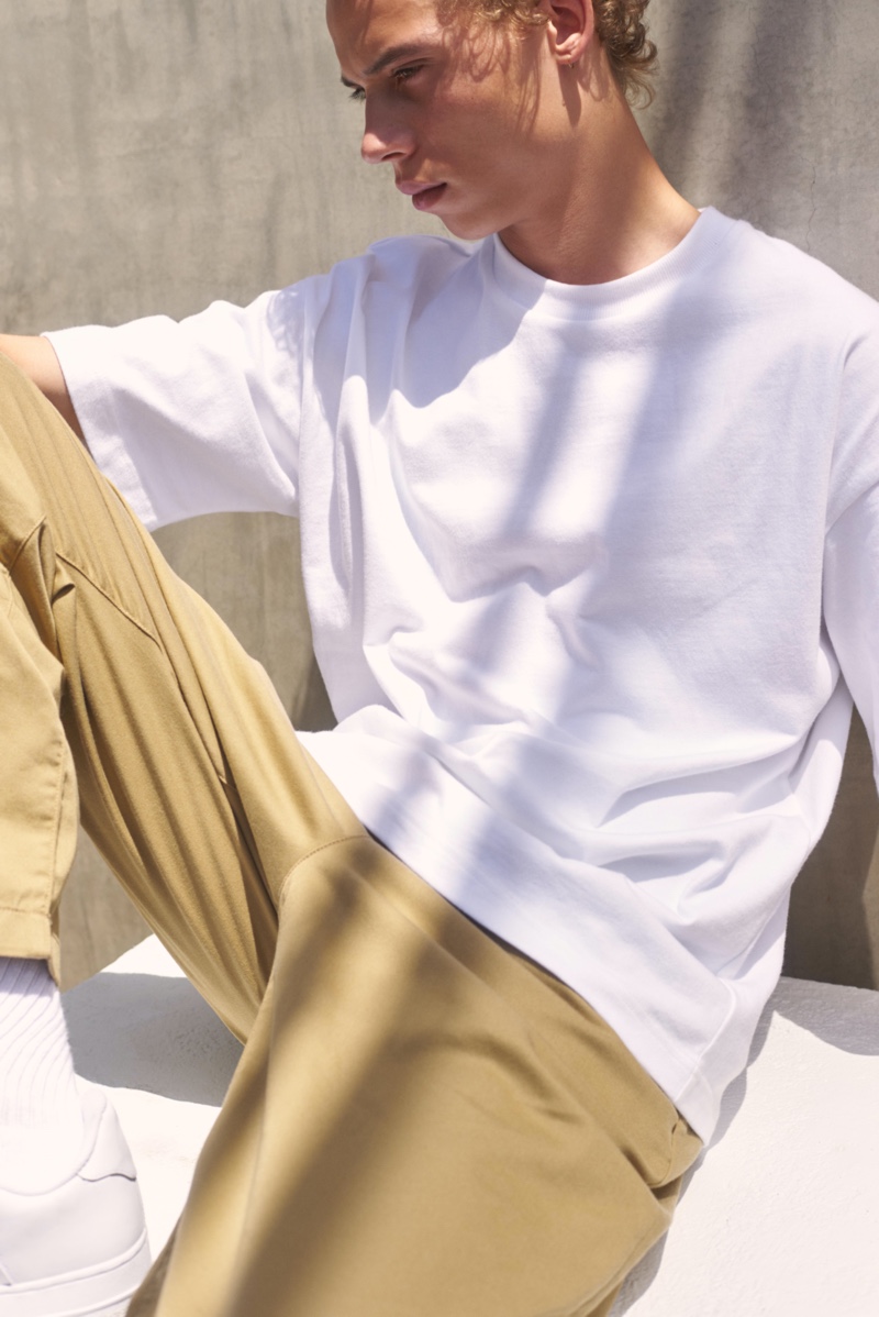 Sporting an oversized tee, Lye-Amone Cassac also wears Levi's Made & Crafted's relaxed chinos.