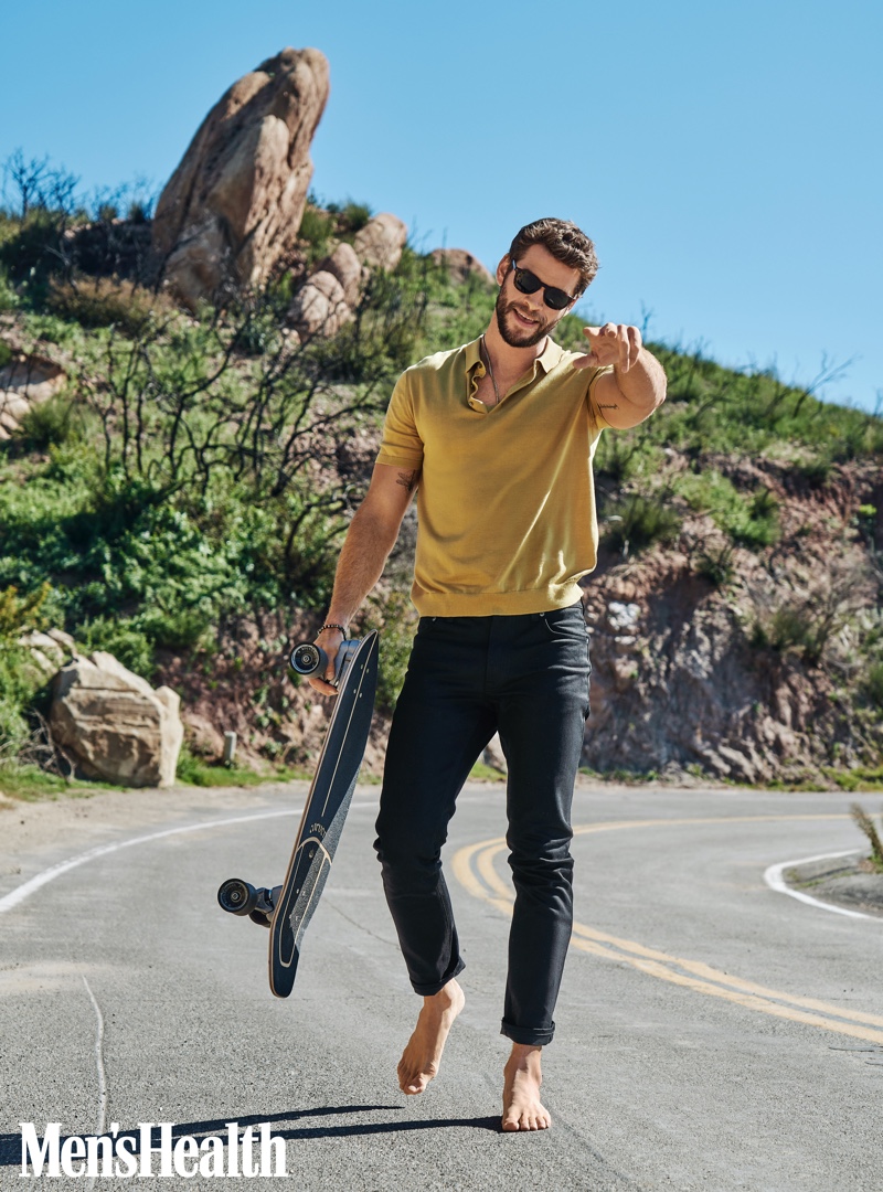 Front and center, Liam Hemsworth sports a COS polo with Outerknown jeans for Men's Health.
