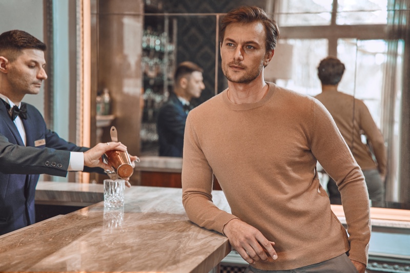 Craig Le Roux sports a brown cashmere sweater from Luca Faloni.