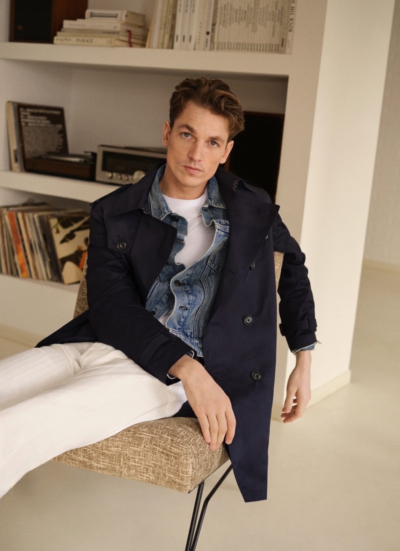 Brushing up on wardrobe staples, Hugo Sauzay dons a jean jacket, trench, and tapered white jeans by Mango.