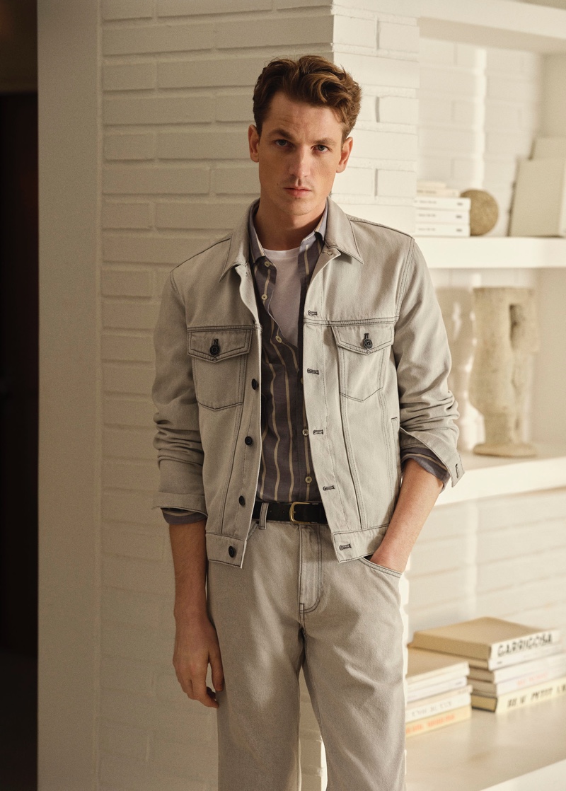 Making the timeless case for double denim, Hugo Sauzay sports a matching gray jean jacket and tapered fit jeans from Mango.
