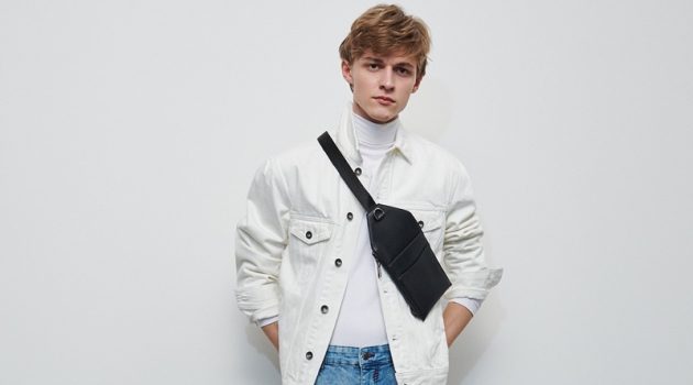 Max Goes Casual in Everyday Looks by Reserved Mixing denim, Max Barczak wears a white trucker jacket and blue rinse jeans from Reserved.
