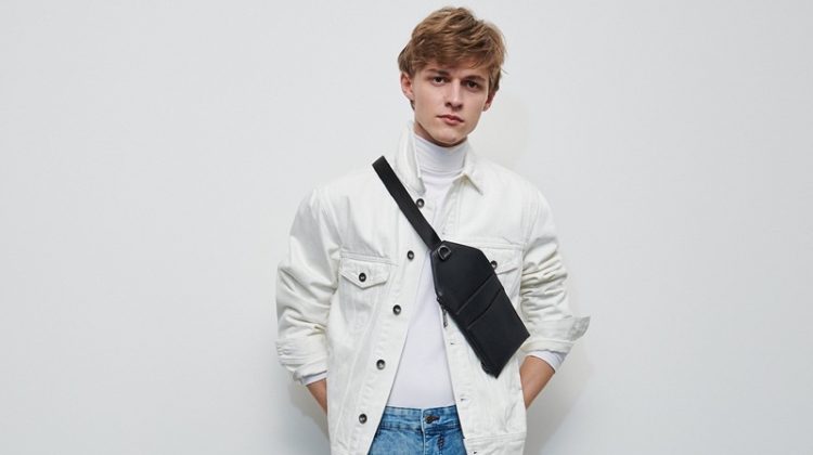 Mixing denim, Max Barczak wears a white trucker jacket and blue rinse jeans from Reserved.