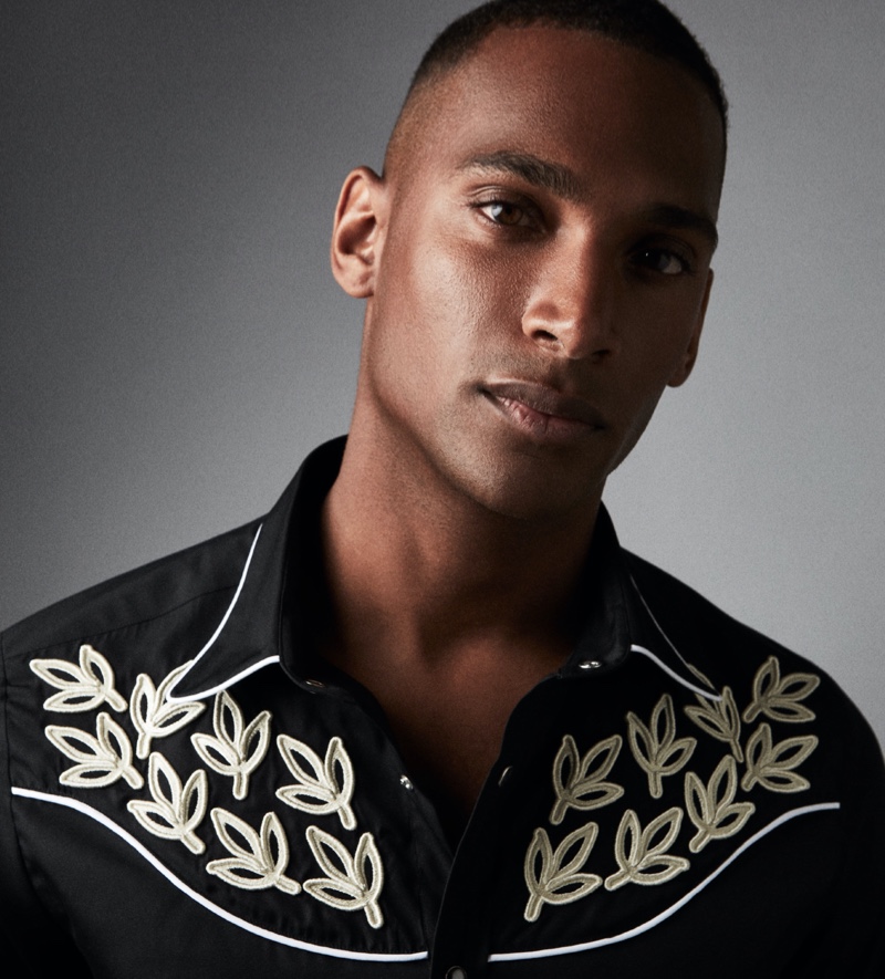 Patrick Nodanche sports a black Caprice embroidered western shirt from Reiss' Americana collection.