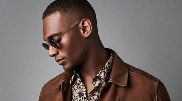 Reiss Goes Western with Americana Collection Embracing western style, Patrick Nodanche models a brown suede Hurst jacket from Reiss. He also rocks the brand's Adder snake print shirt with its Etna jeans and Rio sunglasses.