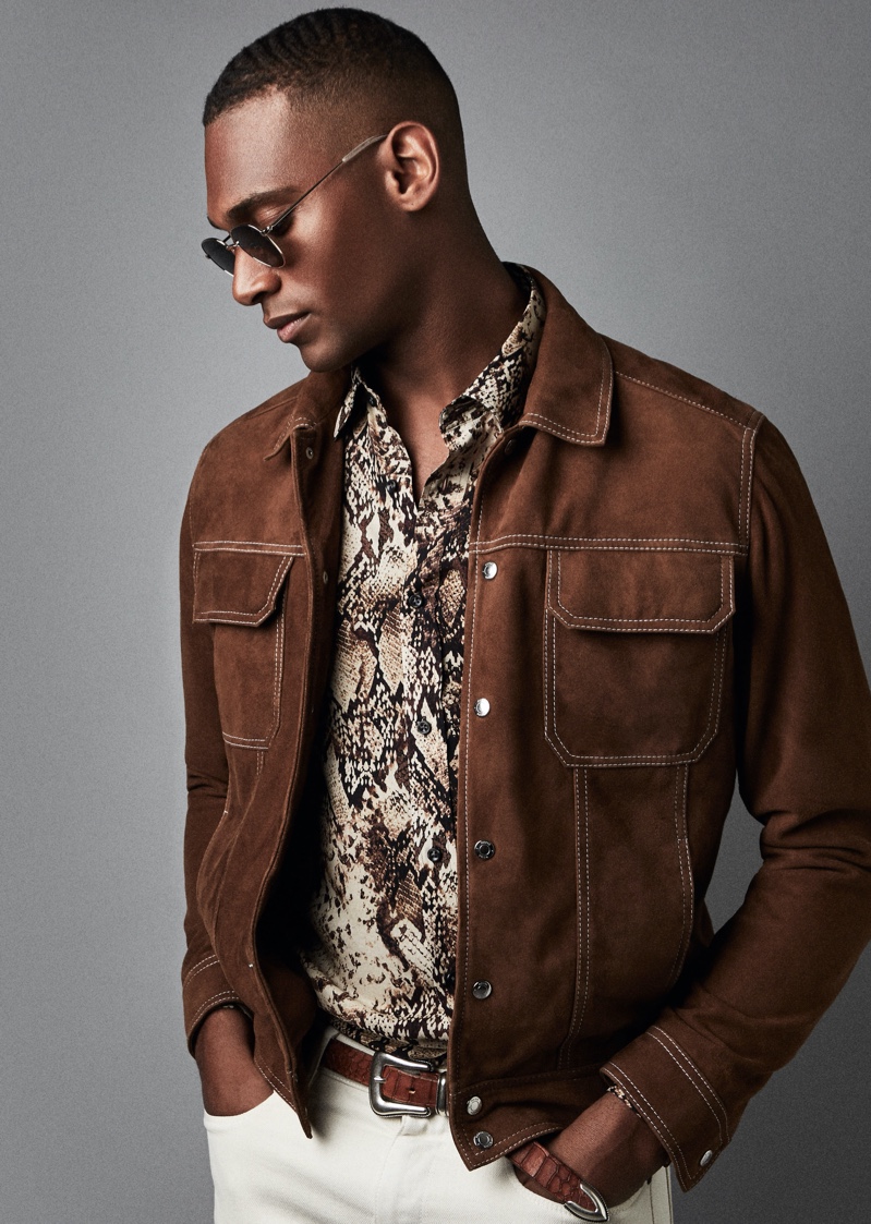 Embracing western style, Patrick Nodanche models a brown suede Hurst jacket from Reiss. He also rocks the brand's Adder snake print shirt with its Etna jeans and Rio sunglasses.
