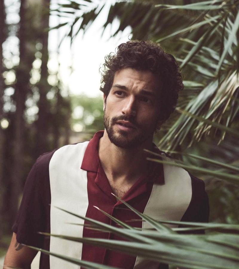 Embracing tropical style for summer, Paul Kelly models a color-block shirt by Scotch & Soda.