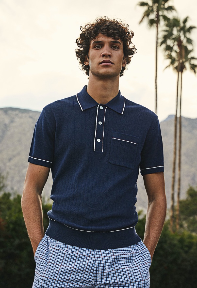 A preppy vision, Francisco Henriques dons Todd Snyder's Italian cotton silk tipped ribbed polo sweater in navy.