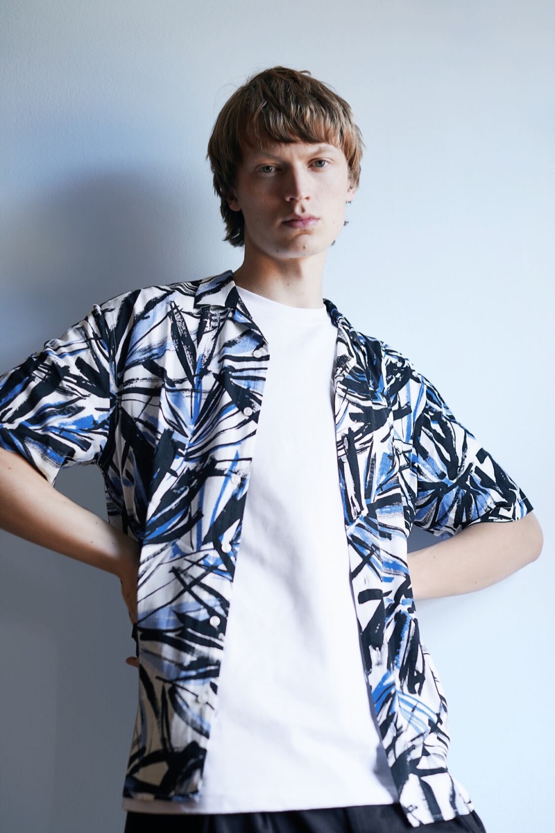 Ready for summer, Jonas Glöer models a tropical print short-sleeve shirt from Zara.