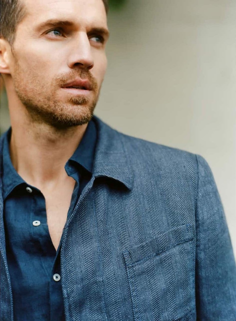 Wearing a look from Massimo Dutti, Andrew Cooper models a linen shirt and herringbone blazer.