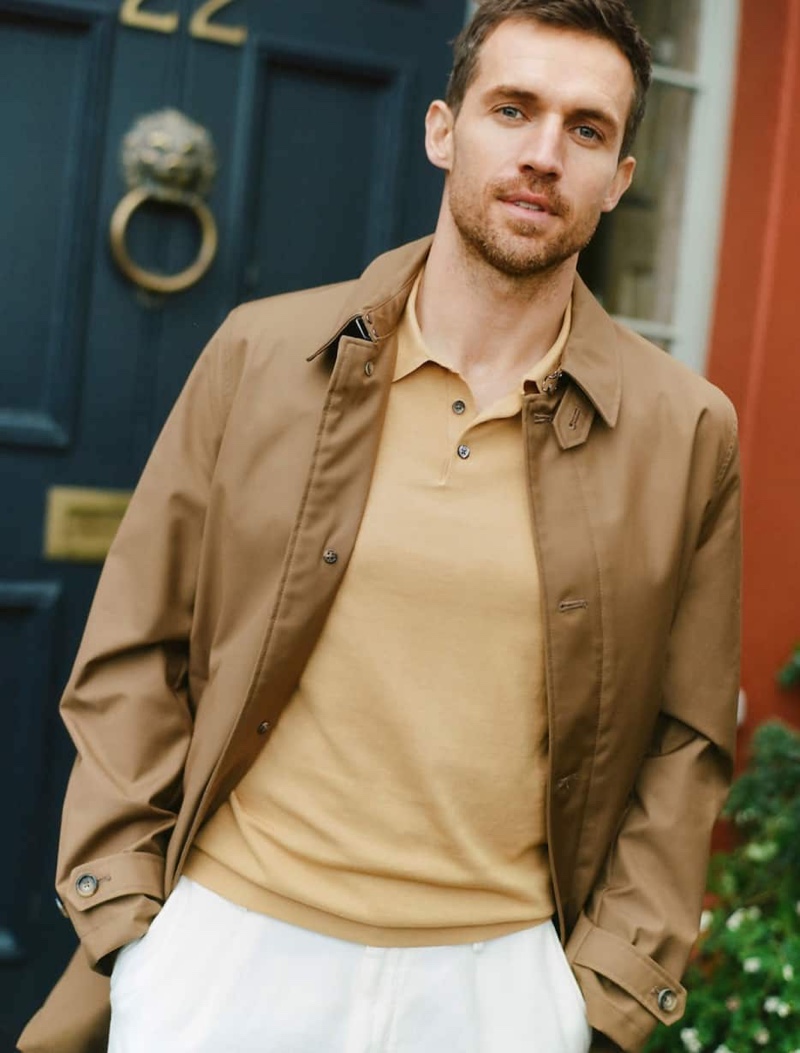 Front and center, Andrew Cooper dons a Massimo Dutti trench-style jacket, polo shirt, and slim-fit chinos.