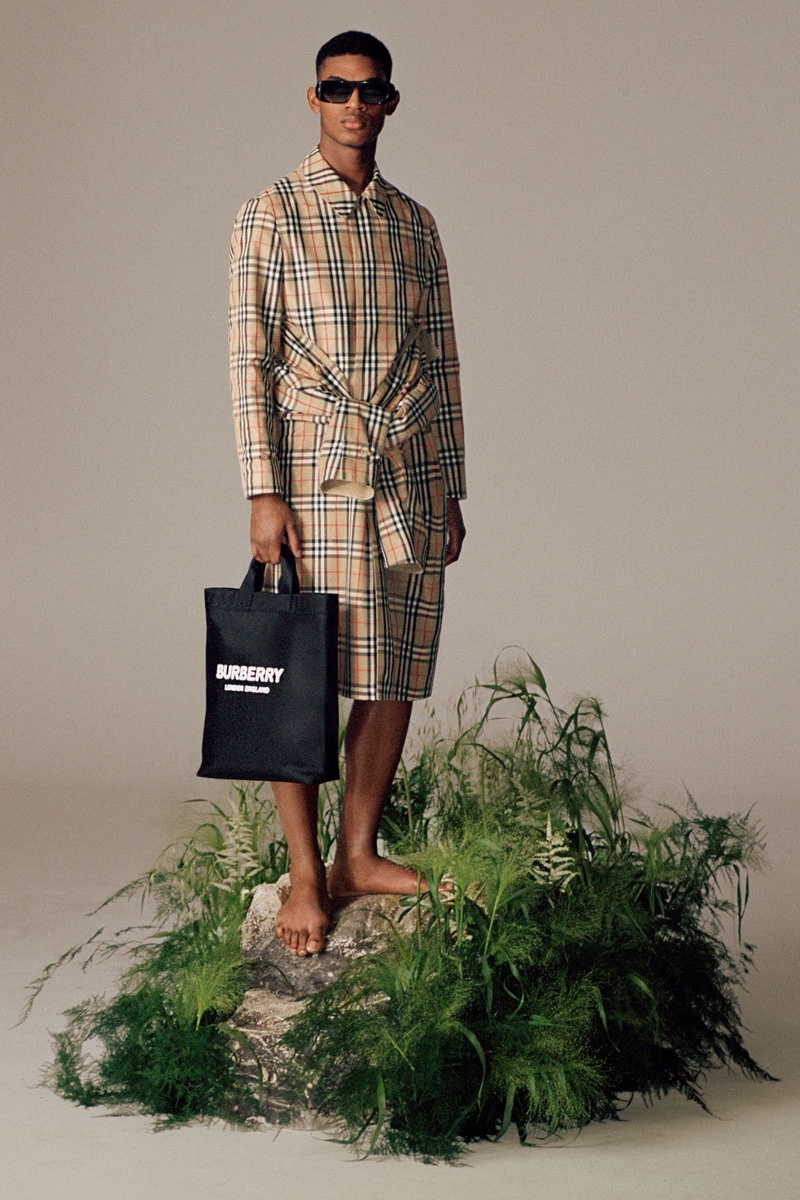 Donning Burberry's famous check, model Reece Nelson takes hold of the brand's logo print ECONYL tote.