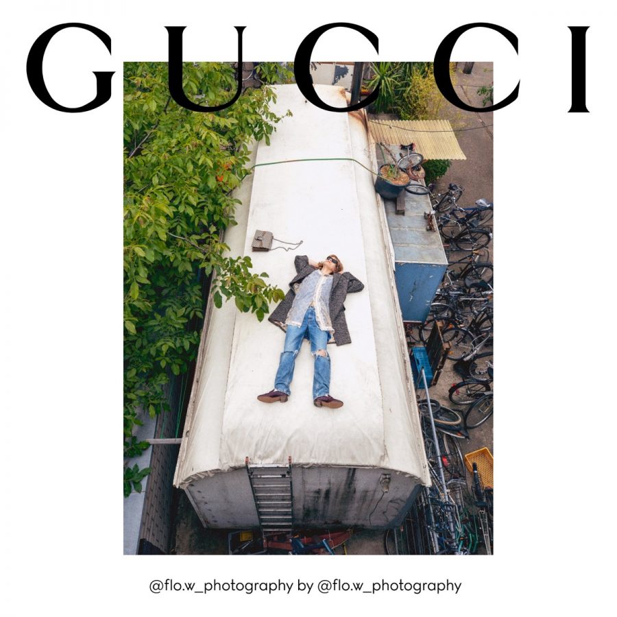 Florian Witte rests on top of a metal building for Gucci's fall 2020 campaign.