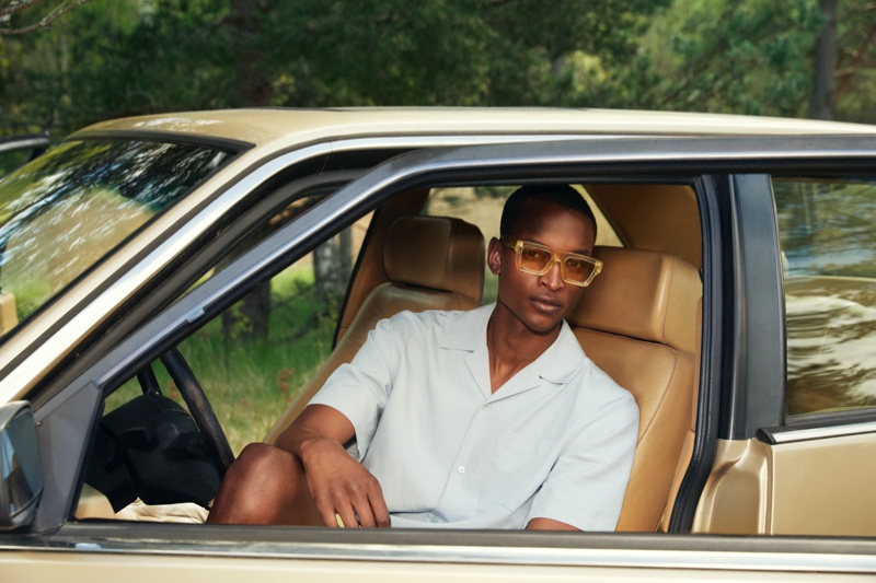 Getting into a vintage car, Oliver Kumbi models sunglasses from the H&M x CHIMI collaboration.