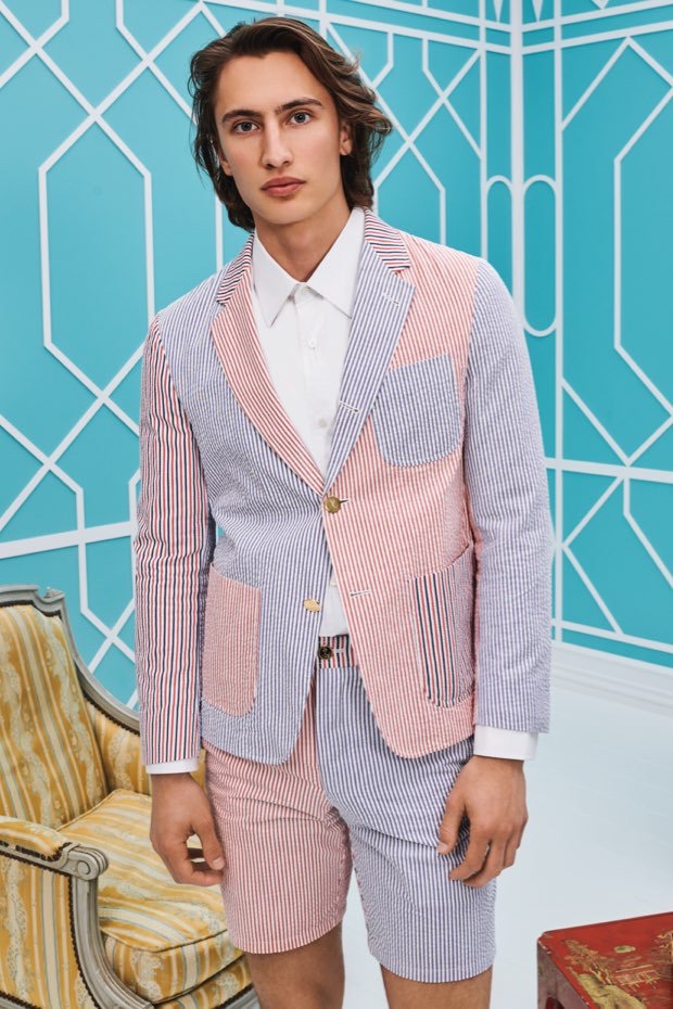 Model James Turlington dons a Thom Browne seersucker jacket and shorts for Holt Renfrew.