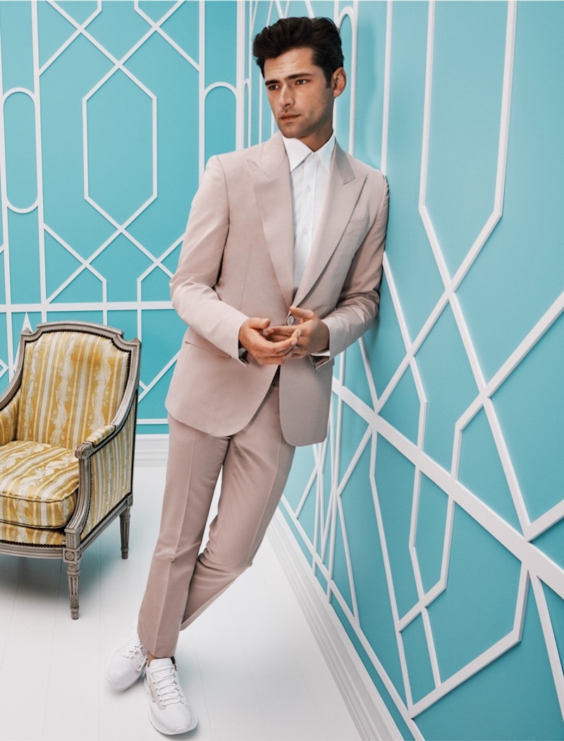 Front and center, Sean O'Pry wears a Givenchy suit with knitted sneakers from Holt Renfrew.