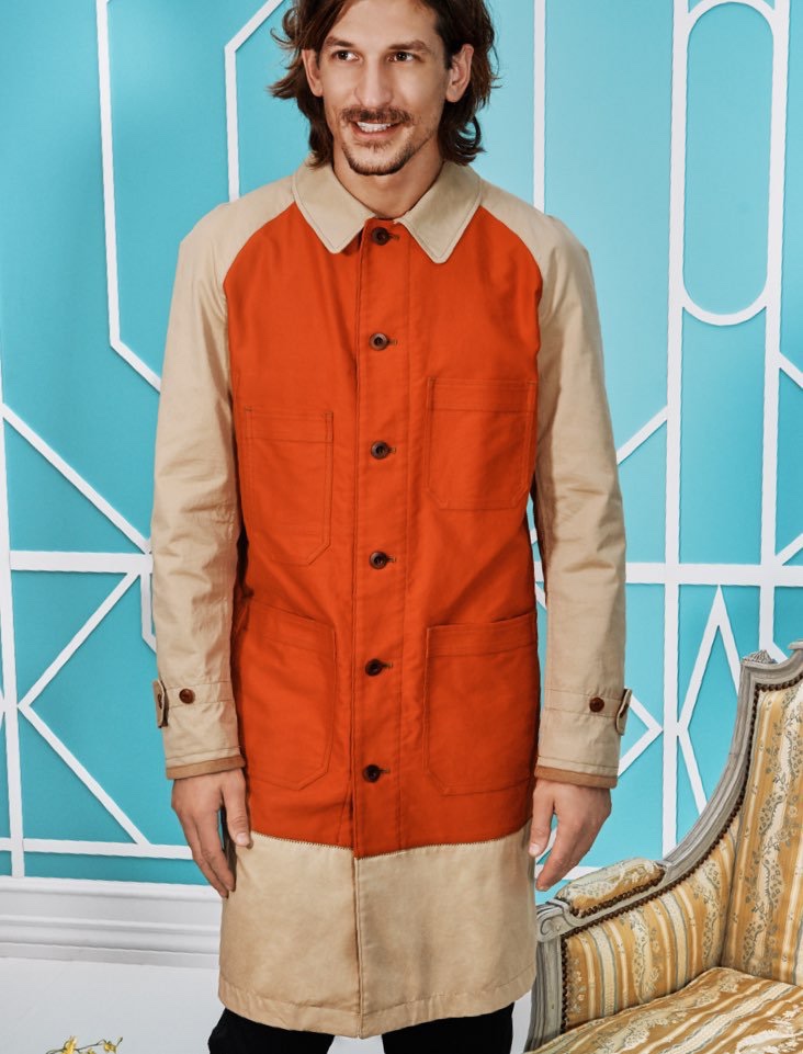 All smiles, Jarrod Scott models a long coat by Junya Watanabe from Holt Renfrew.