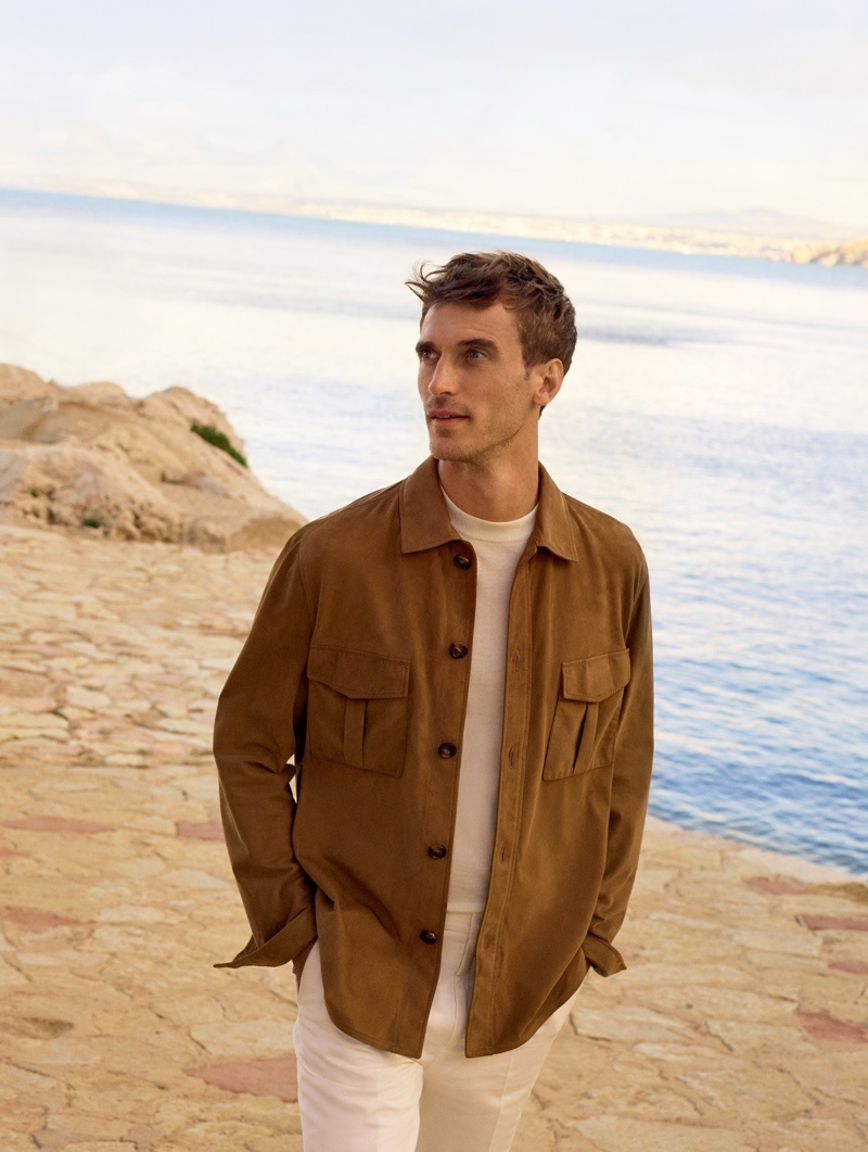 A chic vision, Clément Chabernaud wears a calf skin overshirt with a baby cashmere sweater and pleated pants for Loro Piana's spring-summer 2020 campaign.