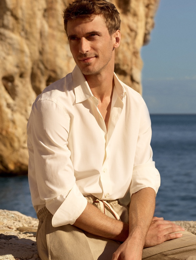 All smiles, Clément Chabernaud dons a cotton and silk shirt with linen crepe trousers for Loro Piana's spring-summer 2020 campaign.