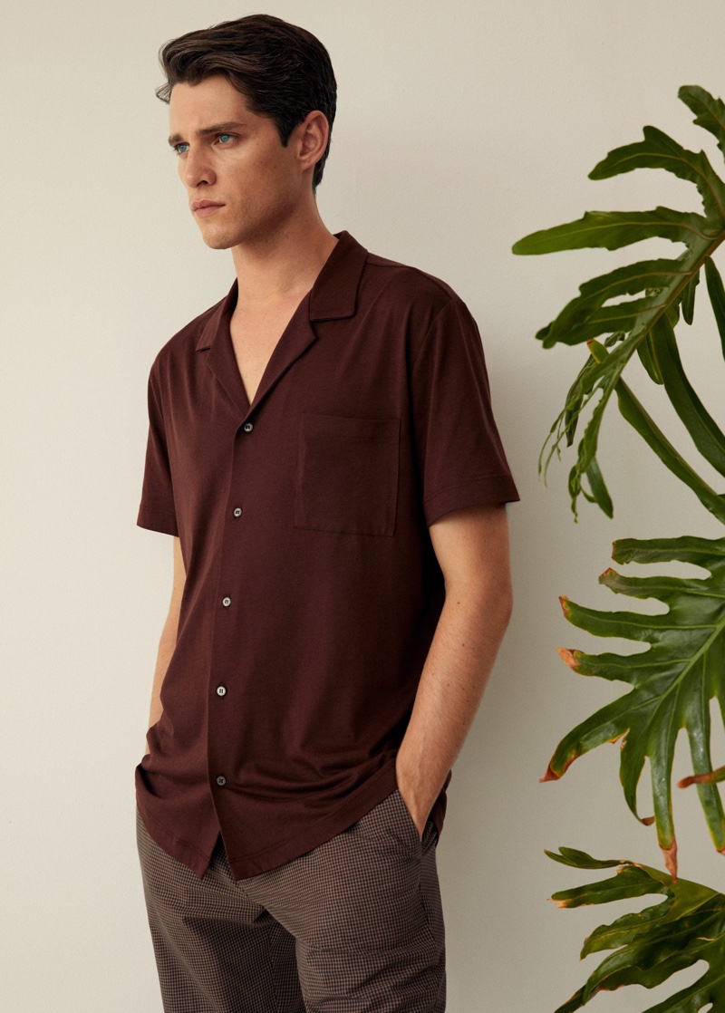 Donning Mango, Luke Powell wears a cotton knit shirt.