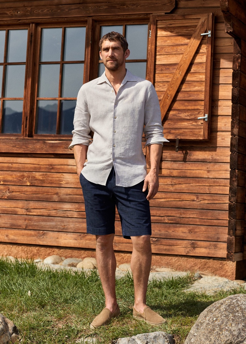 Connecting with Mango, Will Chalker dons a 100% linen slim fit shirt with elastic waist cotton Bermuda shorts.