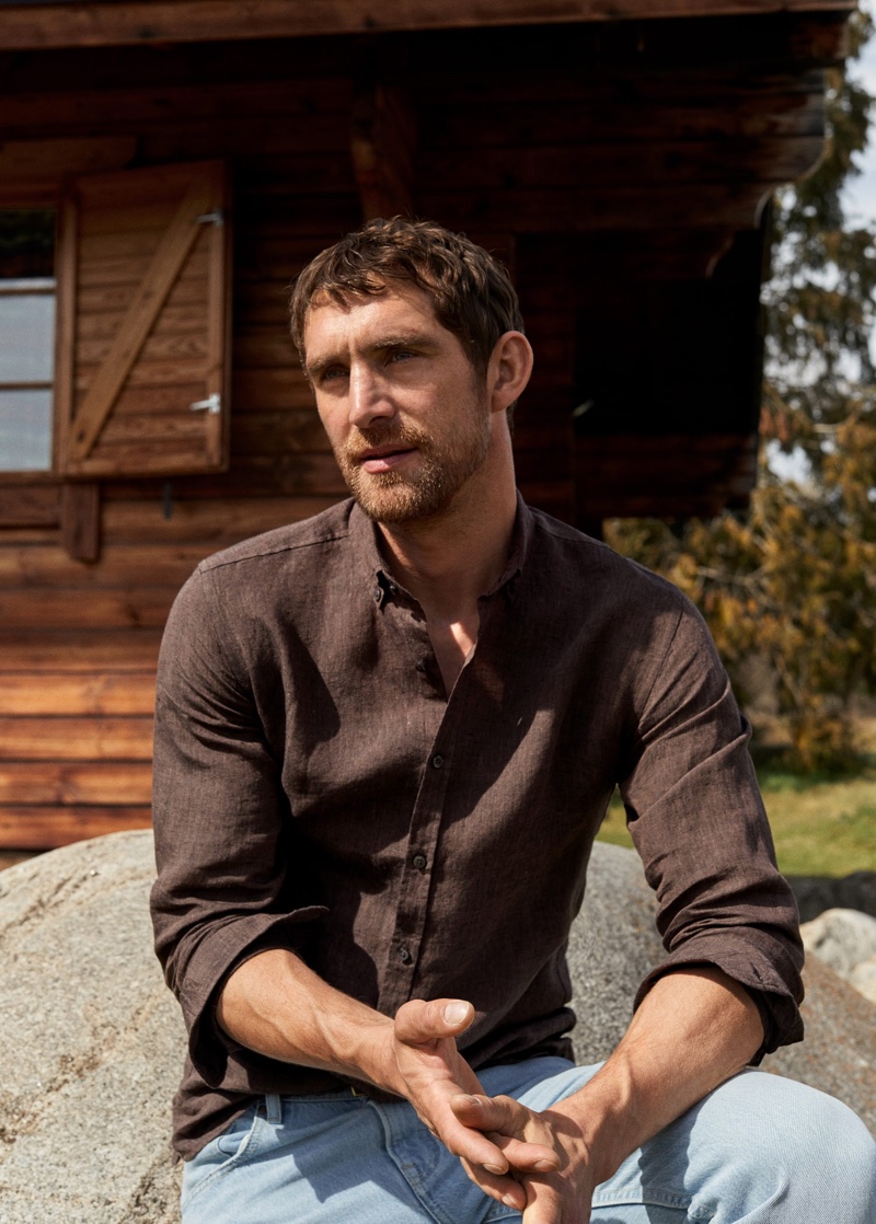 Front and center, Will Chalker models a linen shirt with regular fit light wash Bob jeans from Mango.