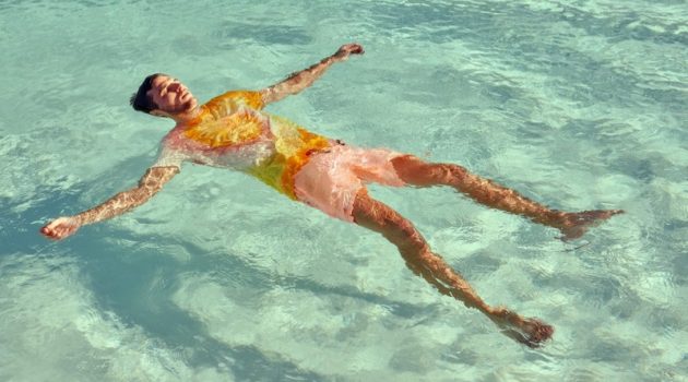 Destination Summer: Arran Sports New Styles from Scotch & Soda Relaxing in the pool, Arran Sly sports a tie dye t-shirt with garment dyed swim shorts from Scotch & Soda.