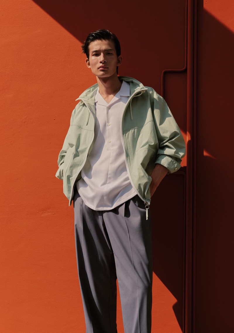 Front and center, Huang Shixin sports a Zara contrasting zipper jacket, textured polo shirt, and pleated suit pants.