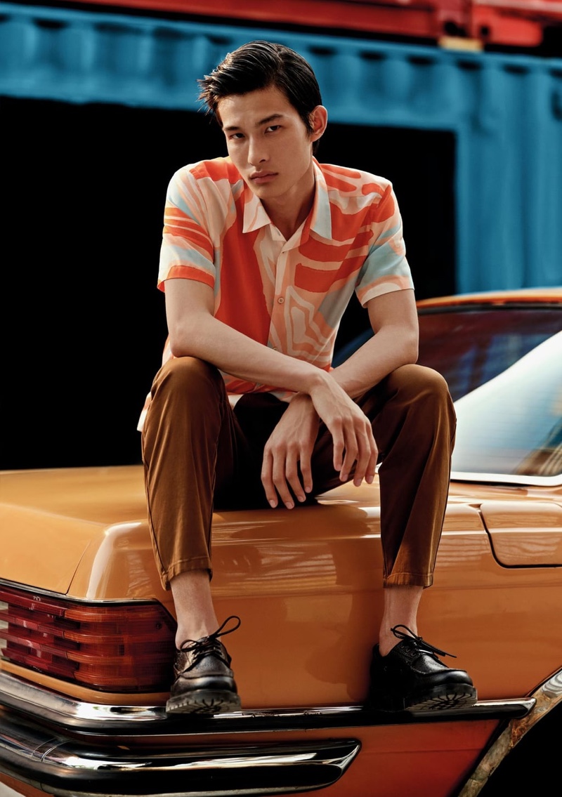 Connecting with Zara, Huang Shixin rocks a bright abstract print shirt and pleated '80s chino pants.