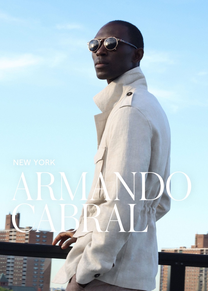 Donning a sleek linen coat, Armando Cabral also wears Mango's clip-on lens sunglasses.