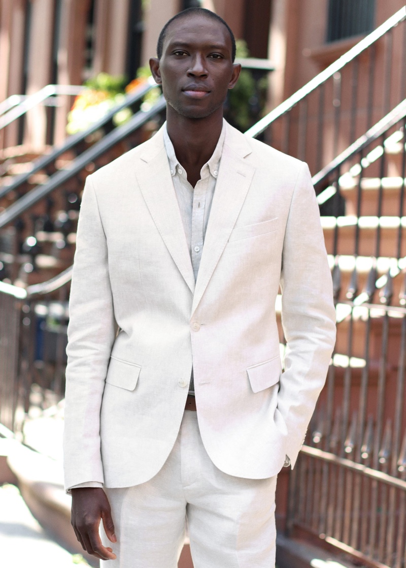 Embracing Mango's Committed line, Armando Cabral models a slim-fit linen suit blazer and pants.